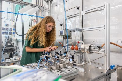 A student works with some of the equipment in the Connecticut Center for Applied Separations Technology (CCAST) lab in the Innovation Partnership Building on June 25, 2024. (Sydney Herdle/UConn Photo)