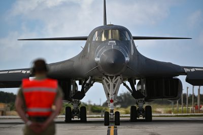 Senior Airman Nevin Konopka, 28th Aircraft Maintenance Squadron assistant dedicated crew chief, awaits the taxi of a B-1B Lancer at Andersen Air Force Base, Guam, May 27, 2024, in support of a Bomber Task Force mission. BTF missions demonstrate lethality and interoperability in support of a free and open Indo-Pacific. (U.S. Air Force photo by Staff Sgt. Jake Jacobsen)