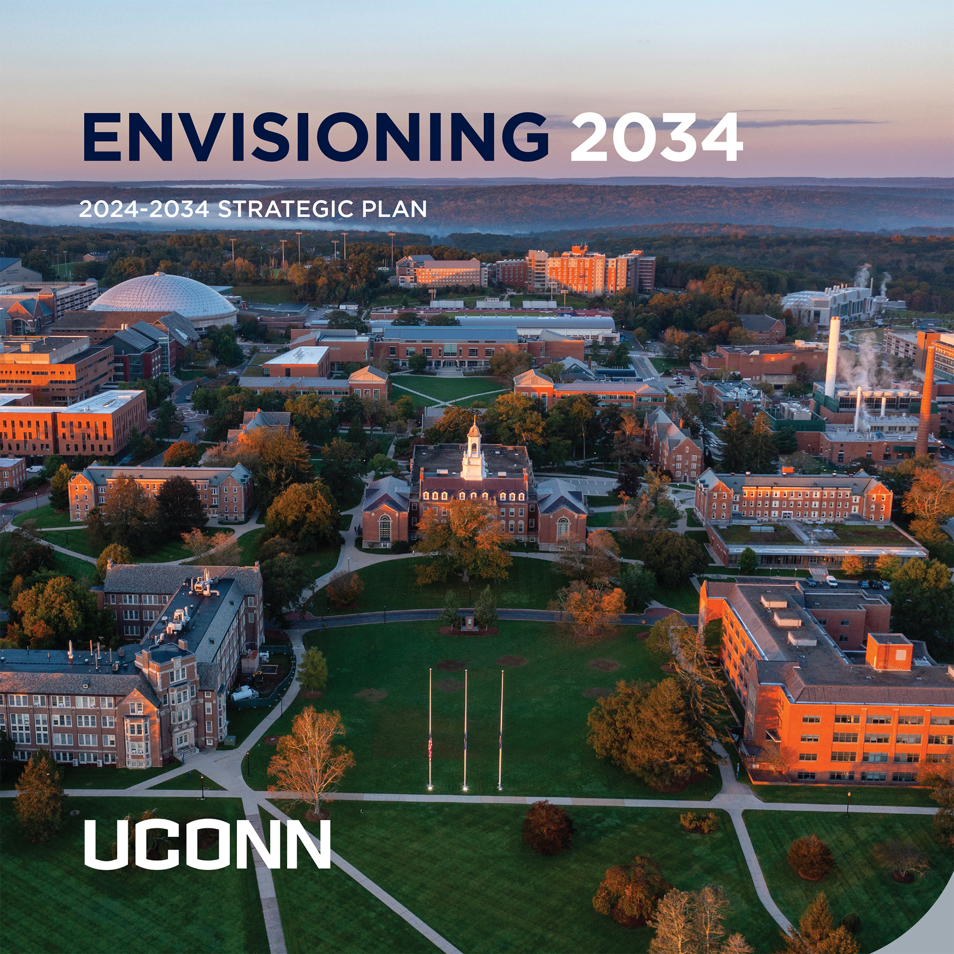 The University of Connecticut's (UConn) 2024-2034 Strategic Plan. The aerial view of the UConn campus at sunset showcases the institution’s iconic architecture and sprawling green spaces, including prominent buildings such as a clock tower and the well-known domed structure.