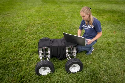 Emily Yale, one of the three inaugural students in our Master's of Engineering in Global Entrepreneurship program, with her autonomous robot at the Great Lawn on Oct. 7, 2019. (Sean Flynn/UConn Photo)