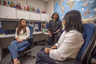 Professor Rebecca Thomas talking with students at the Center for International Social Work Studies at the School of Social Work 