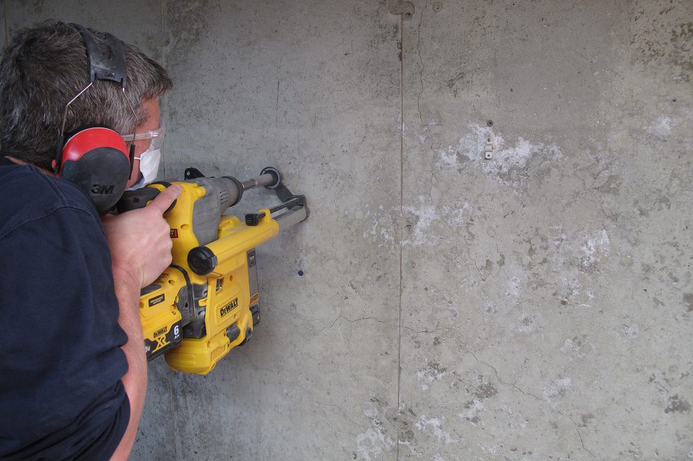 man testing home foundation