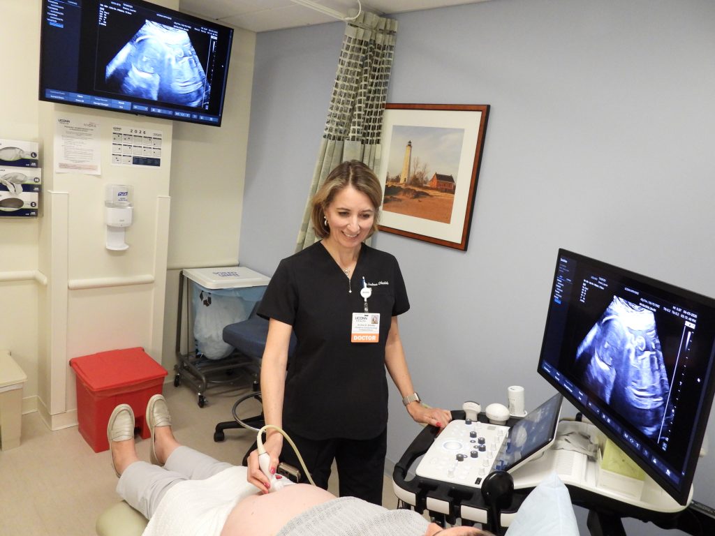 Nurse performing ultrasound on a pregnant woman